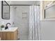 Bathroom showcasing a tiled shower, modern vanity, decorative mirror, and stylish accents at 8120 E 11Th St, Indianapolis, IN 46219