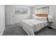 Inviting bedroom showcasing a comfortable bed, soft carpet, and natural light from the windows at 8120 E 11Th St, Indianapolis, IN 46219