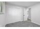 Bright bedroom featuring neutral walls, plush carpeting, and a spacious closet for ample storage at 8120 E 11Th St, Indianapolis, IN 46219