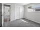 Well-lit bedroom with a large closet, neutral walls, and soft carpeting creating a serene space at 8120 E 11Th St, Indianapolis, IN 46219