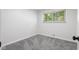 Empty bedroom featuring neutral carpet and walls with a window to add natural light at 8120 E 11Th St, Indianapolis, IN 46219