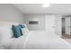 Cozy bedroom with accent pillows, white bedding, and neutral decor at 8120 E 11Th St, Indianapolis, IN 46219