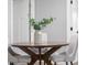 Cozy dining area featuring a round wooden table, seating for three, and modern decor accents at 8120 E 11Th St, Indianapolis, IN 46219