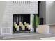 Close-up of the painted fireplace featuring a decorative mantle and candle accents at 8120 E 11Th St, Indianapolis, IN 46219