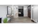 Welcoming foyer features neutral walls, wood-look floors, and convenient coat storage for an organized entry at 8120 E 11Th St, Indianapolis, IN 46219