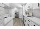 Bright kitchen featuring white cabinets, stainless steel appliances, subway tile backsplash and light wood flooring at 8120 E 11Th St, Indianapolis, IN 46219