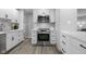 Bright kitchen featuring stainless steel appliances, white cabinets, and white subway tile backsplash at 8120 E 11Th St, Indianapolis, IN 46219