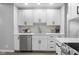 Updated kitchen featuring white cabinets, stainless steel appliances, and white subway tile backsplash at 8120 E 11Th St, Indianapolis, IN 46219