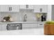 Close up of kitchen featuring white subway tile backsplash, stainless steel appliances, and white countertops at 8120 E 11Th St, Indianapolis, IN 46219