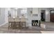 Open-concept living space with a fireplace, kitchen island, and modern bar stools at 8120 E 11Th St, Indianapolis, IN 46219