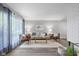 Cozy living area features neutral decor, a fireplace, and large windows with natural light at 8120 E 11Th St, Indianapolis, IN 46219