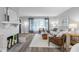 Inviting living space showcasing a brick fireplace and abundant natural light from the large front window at 8120 E 11Th St, Indianapolis, IN 46219
