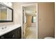 Updated bathroom features a modern vanity with a white countertop and a view to the next bedroom at 813 Stoner Dr, Anderson, IN 46013