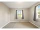 Bright bedroom with neutral walls, carpet flooring, and a large window offering plenty of natural light at 813 Stoner Dr, Anderson, IN 46013