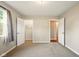 Spacious bedroom featuring plush carpeting, closet, and a view into the adjacent room at 813 Stoner Dr, Anderson, IN 46013