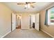 Spacious bedroom with ceiling fan and two doorways to other rooms at 813 Stoner Dr, Anderson, IN 46013