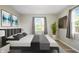 Staged bedroom boasts a sleek bed frame, modern decor, and natural light, creating a calming space at 813 Stoner Dr, Anderson, IN 46013