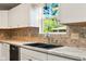Close up of kitchen highlighting sink and view from the window at 813 Stoner Dr, Anderson, IN 46013
