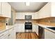 Bright kitchen with stainless appliances and luxury vinyl flooring at 813 Stoner Dr, Anderson, IN 46013