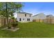 Exterior elevation of the home's back yard, including a well-manicured lawn and a wood fence at 8158 S Firefly Dr, Pendleton, IN 46064