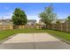 Large backyard with a concrete patio, grassy lawn, and wood fence, perfect for outdoor activities and entertaining at 8158 S Firefly Dr, Pendleton, IN 46064