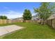 Exterior elevation of a backyard featuring a well-maintained lawn, concrete patio and a privacy fence at 8158 S Firefly Dr, Pendleton, IN 46064