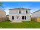 Exterior elevation of the home's back yard, including a well-manicured lawn and a concrete patio at 8158 S Firefly Dr, Pendleton, IN 46064
