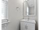 Brightly lit bathroom featuring a sink and vanity and a large mirror adjacent to a window at 8158 S Firefly Dr, Pendleton, IN 46064