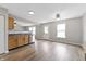 Open kitchen features wood-look flooring, stainless steel appliances, window, and rear door at 8158 S Firefly Dr, Pendleton, IN 46064