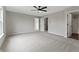 Spacious carpeted main bedroom featuring a ceiling fan and ensuite bathroom and walk-in closet entrances at 8158 S Firefly Dr, Pendleton, IN 46064