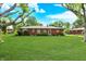 Spacious backyard featuring lush green lawn and the back side of the house at 8230 Linda Leigh Ln, Indianapolis, IN 46217