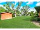 Expansive backyard featuring a lush green lawn and a storage shed with a wooden door at 8230 Linda Leigh Ln, Indianapolis, IN 46217