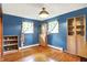 Cozy bedroom with wood floors, natural light, and ample storage in built-in shelves at 8230 Linda Leigh Ln, Indianapolis, IN 46217
