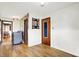 Hallway with wood floors and view to laundry room at 8230 Linda Leigh Ln, Indianapolis, IN 46217