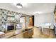 Bright living room with wood floors, a fireplace, and a white piano at 8230 Linda Leigh Ln, Indianapolis, IN 46217