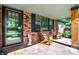 Cozy brick porch with rocking chairs, a glass storm door, and neutral brick flooring at 8230 Linda Leigh Ln, Indianapolis, IN 46217