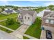 Aerial view of home featuring a two-car garage, lush lawn, and tranquil lake views at 8238 Crackling Ln, Indianapolis, IN 46259
