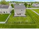Aerial view showcasing a home with a well-kept lawn, patio area, and fenced perimeter at 8238 Crackling Ln, Indianapolis, IN 46259