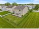 Aerial view of a home with a backyard featuring an expansive lawn, fenced perimeter, and patio at 8238 Crackling Ln, Indianapolis, IN 46259