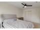 Bedroom with a comfortable queen bed, a ceiling fan, closet, and a wooden shelf for storage at 8238 Crackling Ln, Indianapolis, IN 46259