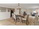 Dining room with table and chairs. Adjacent is a living room and staircase at 8238 Crackling Ln, Indianapolis, IN 46259