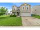 Charming two-story home with a well-maintained lawn and attached two-car garage at 8238 Crackling Ln, Indianapolis, IN 46259