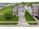 Aerial shot of a two-story home with a well-maintained lawn, two car garage and near a tranquil pond at 8238 Crackling Ln, Indianapolis, IN 46259