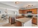 Functional kitchen with an island, wood cabinets, and stainless steel appliances at 8238 Crackling Ln, Indianapolis, IN 46259