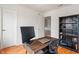 A home office with a spacious desk, bookcase, and plenty of natural light at 8238 Crackling Ln, Indianapolis, IN 46259