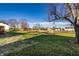 Expansive backyard featuring a storage shed, a large, open grassy area, and a deck at 8510 E Mcgregor Rd, Indianapolis, IN 46259