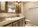 This bathroom features a sink with cabinet, toilet, and a custom medicine cabinet at 8510 E Mcgregor Rd, Indianapolis, IN 46259