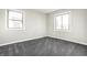This bedroom features neutral walls, gray carpet, and dual windows providing ample natural light at 8510 E Mcgregor Rd, Indianapolis, IN 46259