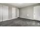This bedroom features neutral walls and gray carpet with multiple closets at 8510 E Mcgregor Rd, Indianapolis, IN 46259