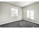 This bedroom features neutral walls, gray carpet, and a window providing ample natural light at 8510 E Mcgregor Rd, Indianapolis, IN 46259